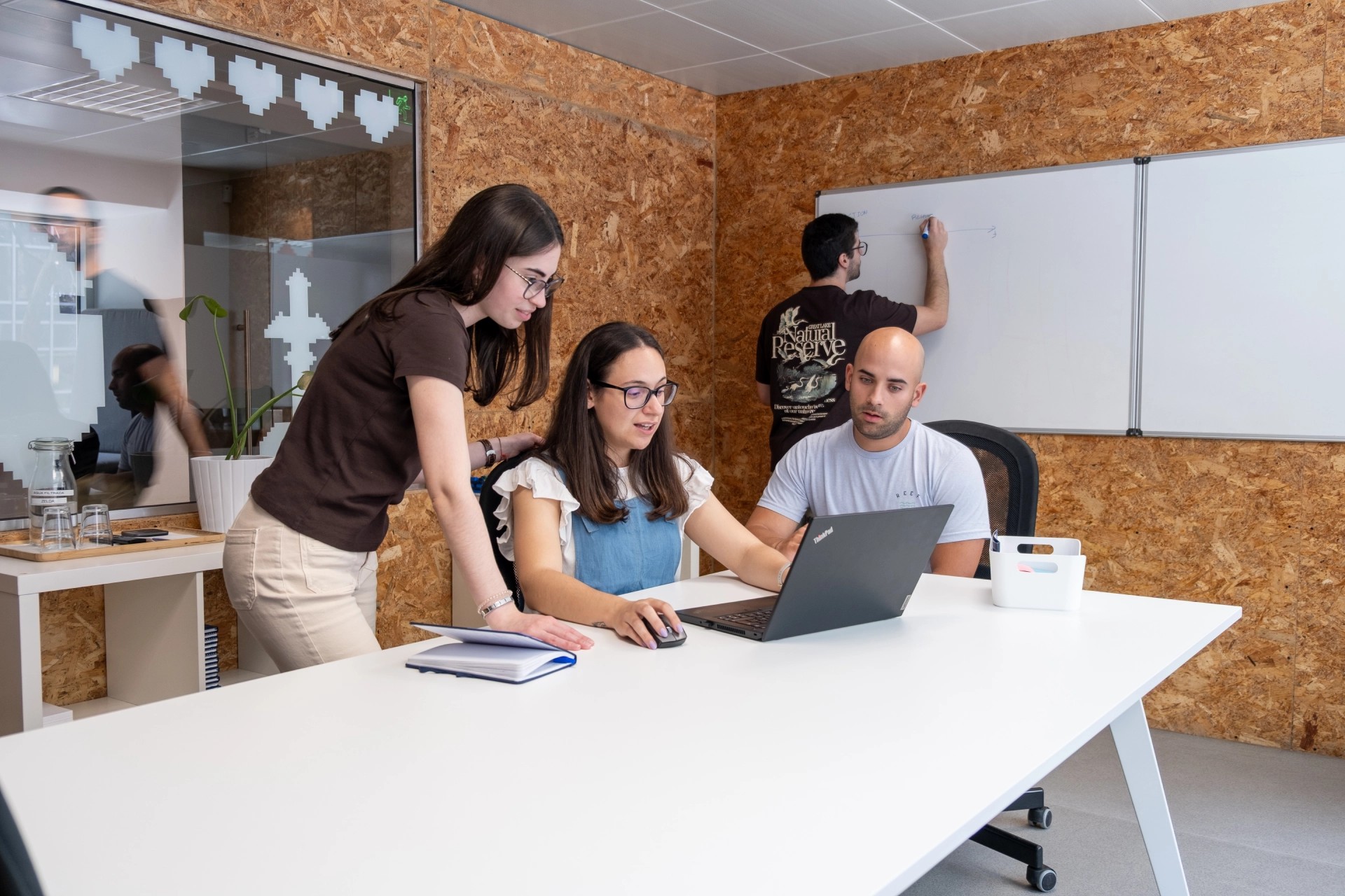 Group of young people working together and focusing on solving programming problems at Premium Minds' office