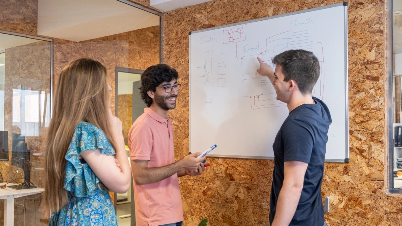 Group of young people working together and focusing on solving programming problems at Premium Minds' office
